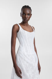 A model wearing a white sleeveless lace dress against a light gray studio background.