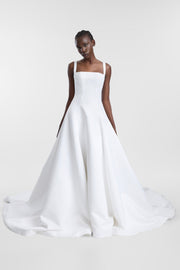 A woman modelling a white, square-neck a-line wedding gown