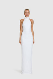 Woman wearing a structured white halter neck dress on a white background